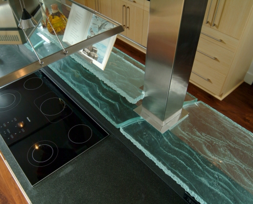 contemporary coastal kitchen design detail. Custom design glass shelf around columns over cooktop