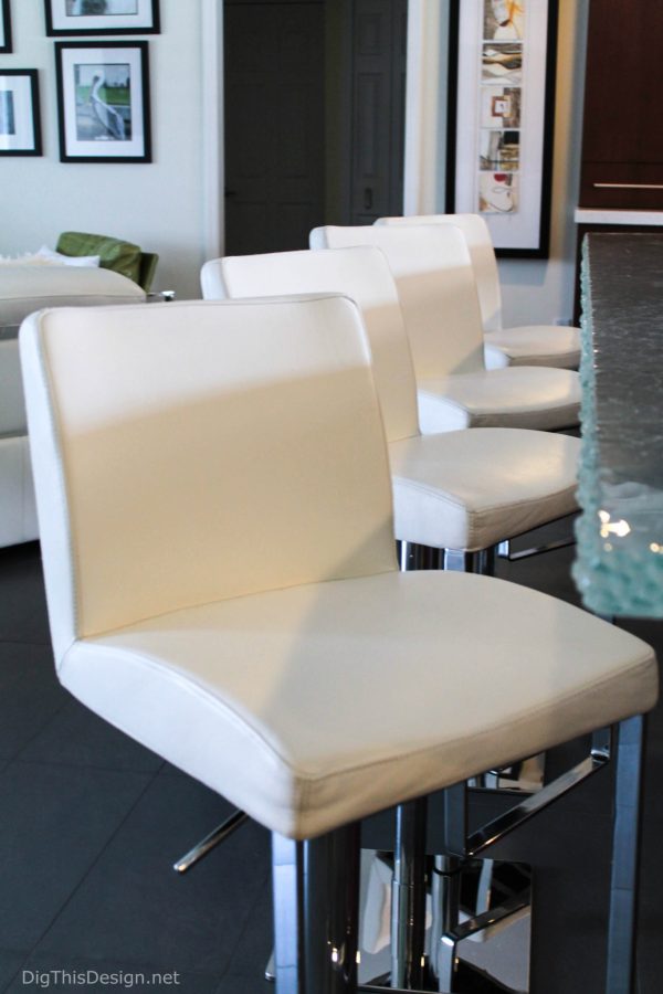 A row of modern white leather bar stools with chrome base after being cleaned