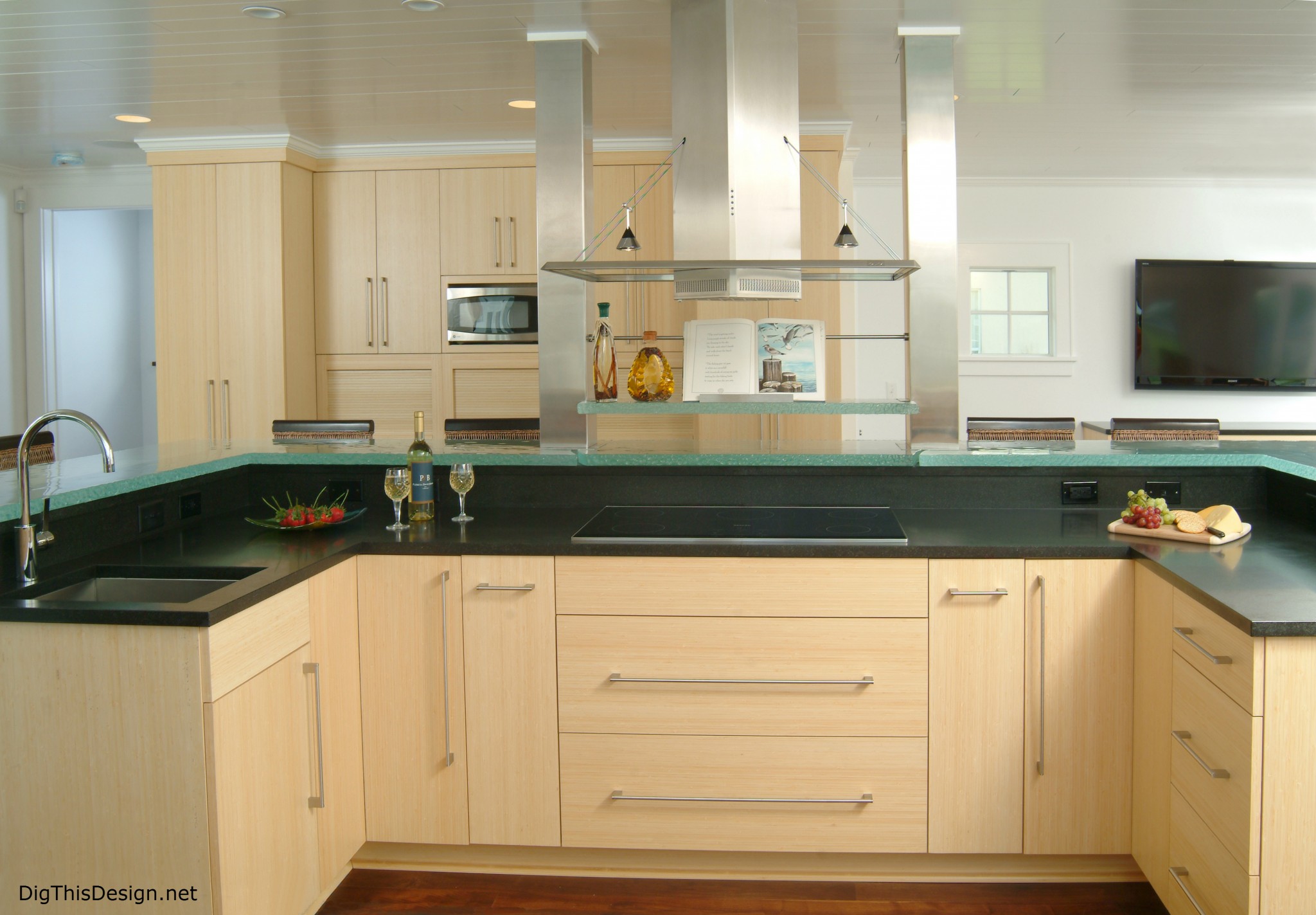 contemporary modern kitchen with stainless steel hood black counter tops bamboo cabinetry