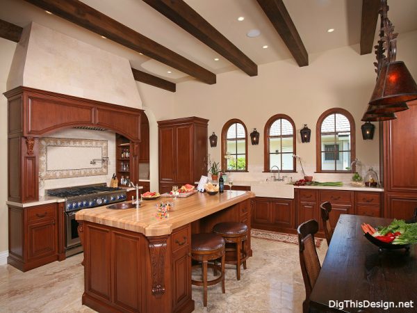 old world traditional kitchen interior design with wood cabinets island and exposed rafters