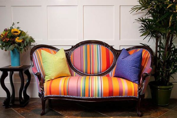 Colorful stripped upholstered Victorian couch by Darci Good Design.
