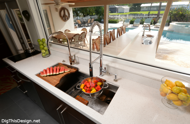 Kallista chef sink with accessories in a modern coastal kitchen with large window view