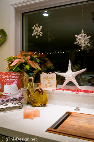 Christmas window sill decor at sink with cookbook starfish and poinsettia 