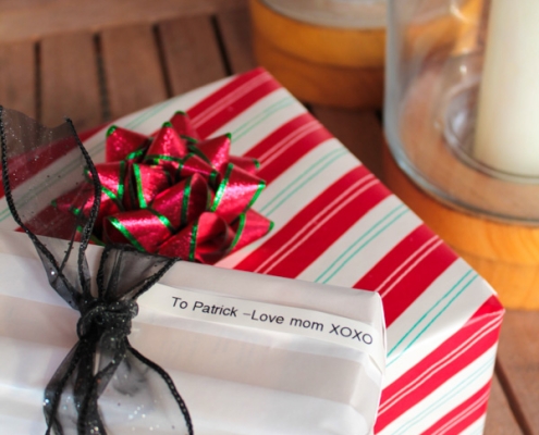 custom greeting label on wrapped Christmas presents