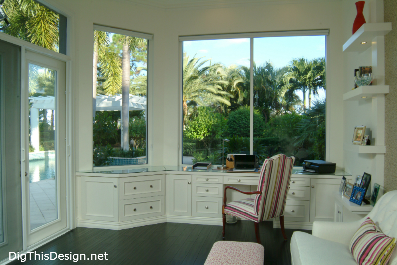 high end home office in coastal style with large window views and white interior