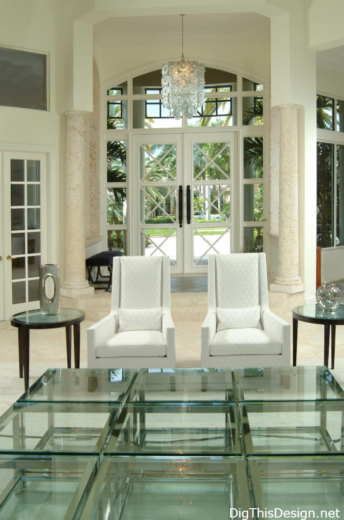 coastal luxury home entry foyer with white furniture and glass decor