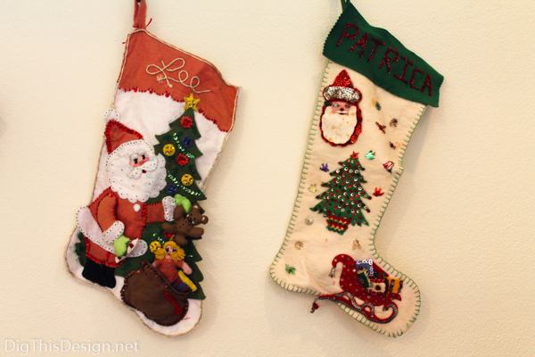 Handmade DIY family heirloom Christmas stockings hanging from windowsill as holiday decor