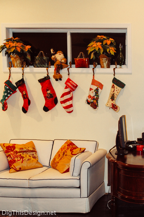 Windowsill holiday decor with Christmas ornaments and stockings