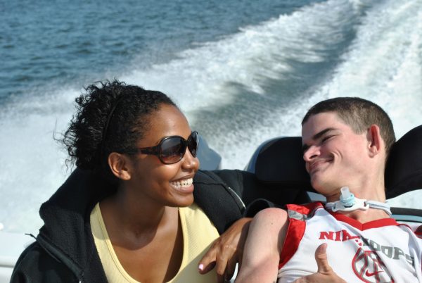 Wheelchair bound young man enjoying a boat ride.