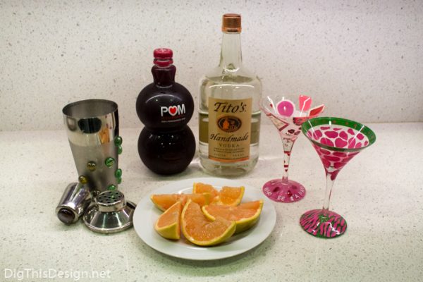 Ingredients for healthy vodka cocktail for Valentine's Day. Pomegranate juice, fresh grapefruit, tito's vodka, martini glasses 