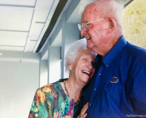 Picture of a loving elderly couple laughing.