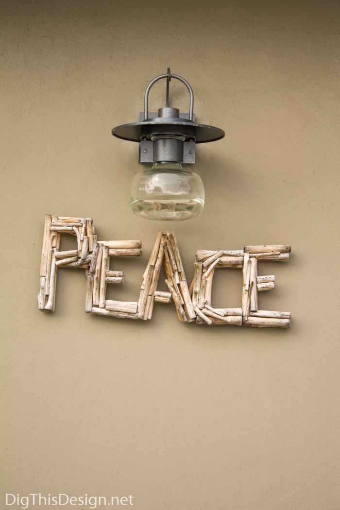Driftwood peace sign decor with Hubbardton Forge Mason lantern.