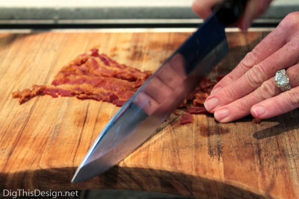Chopping crispy bacon for deviled eggs toping.
