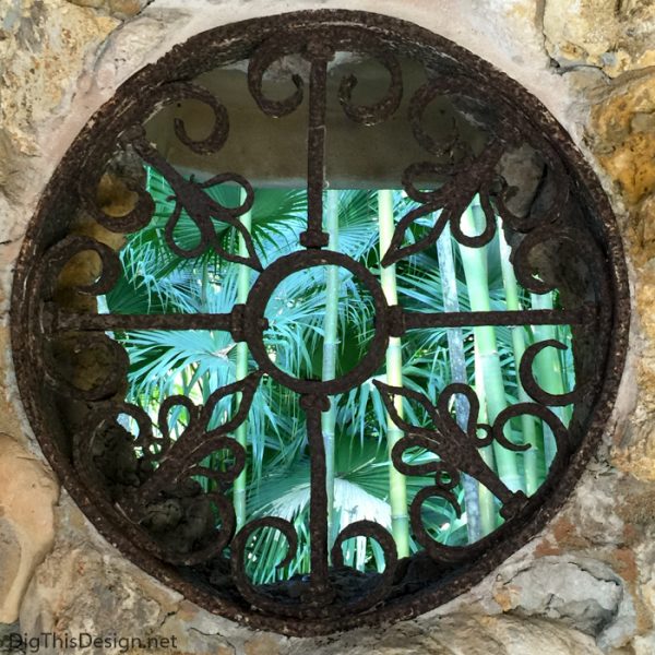 Old wrought iron medallion inbedded into the coral wall of the Spanish kitchen at McKee Botanical Garden. 