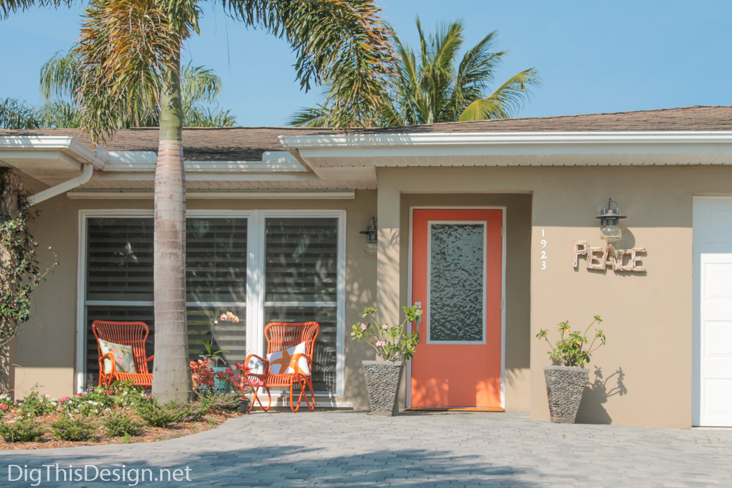 View of the house with completed front porch project accented with orange.