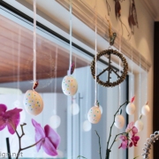 Easter decor with hanging decorative hollow eggs for window or fireplace mantle decor.