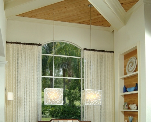 Large cube shaped chandeliers hanging in a dining room. Design by Patricia Davis Brown Designs, llc.