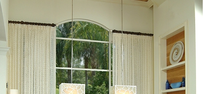 Large cube shaped chandeliers hanging in a dining room. Design by Patricia Davis Brown Designs, llc.