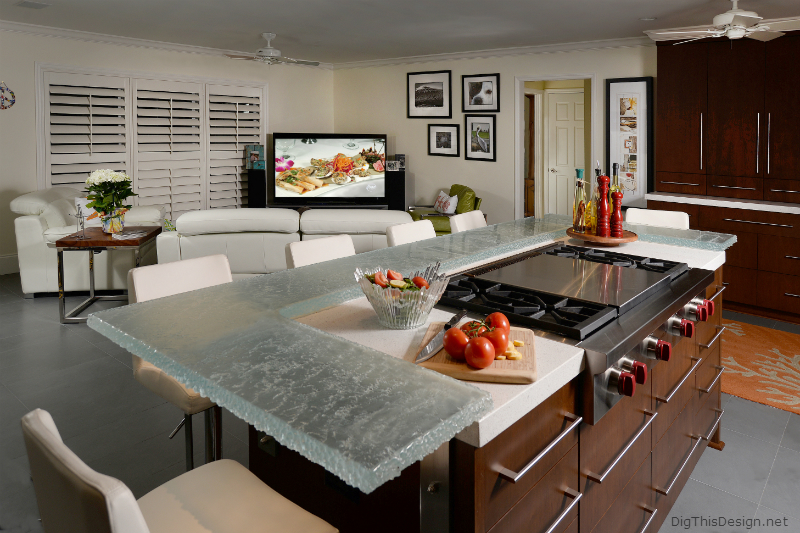 Glass countertop around island in a contemporary coastal kitchen.