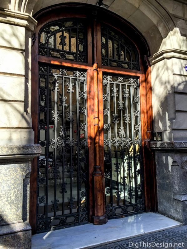 A door in Barcelona made up of wrought iron and wood.