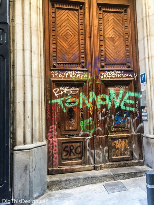 Graffiti art on a beautiful wood carved door in Barcelona.
