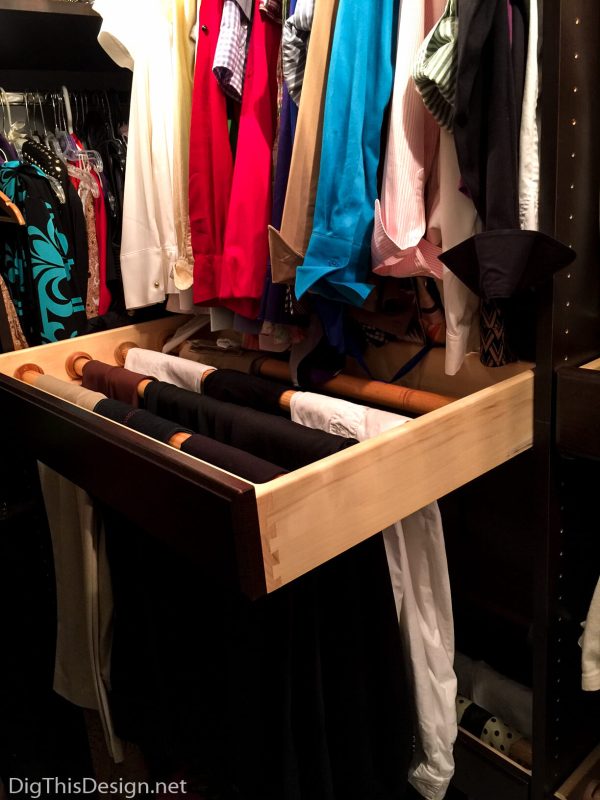 Maximizing your home storage starts with clever organizing solutions like this pull out pant storage system.