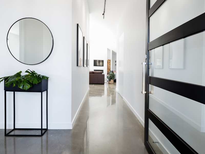 Foyers; contemporary entry way with polished concrete floors