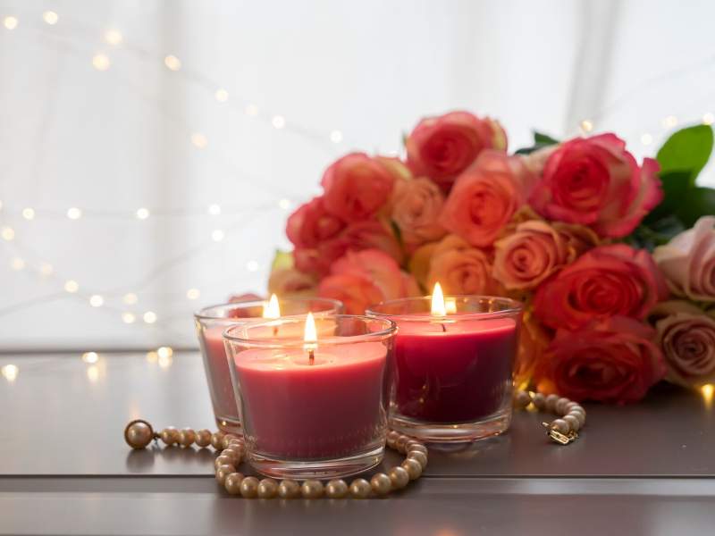 Romantic scented red candles and roses for valentine decor