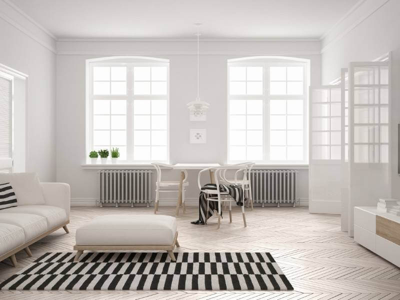 White modern living room with pops of green and soft black