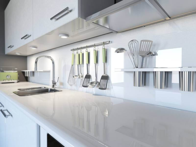 White modern kitchen with subtle pops of summer green