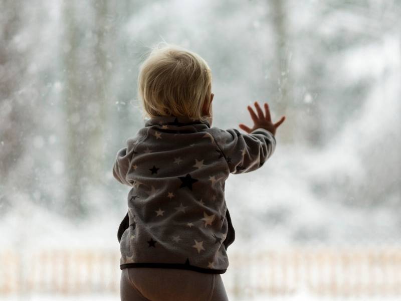 Baby Looking out Window at Snow