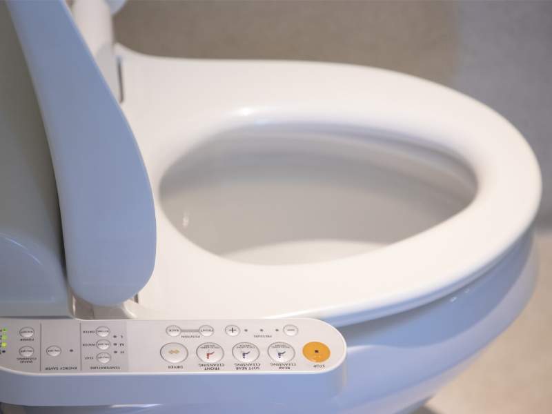 A modern bathroom dual-flush toilet.