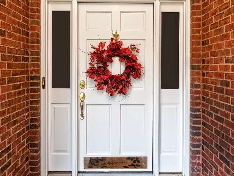 Unique and Colorful Autumn Wreath Ideas - Orange Leaves on a White Door