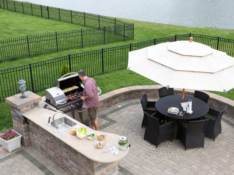 6 Easy Steps to a Beautiful Outdoor Living Space - Outdoor Patio Fire Pit with an outdoor kitchen built into a brick deck.