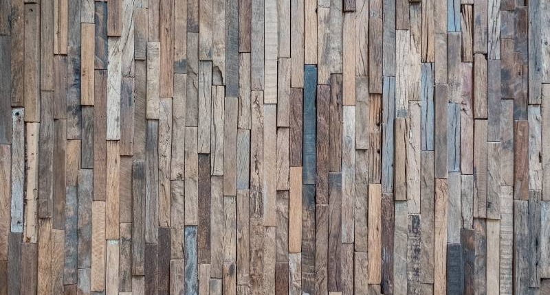 12 Unique Ways to Bring Reclaimed Wood into Your Home - vertical pattern of reclaimed wood for walls. Uses narrow pieces for a modern rustic look.