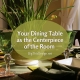 Designing Your Dining Table to be the Centerpiece of the Room - Natural texture setting with bulbs sprouting in a low bowl with green glass ware and earthy table settings.