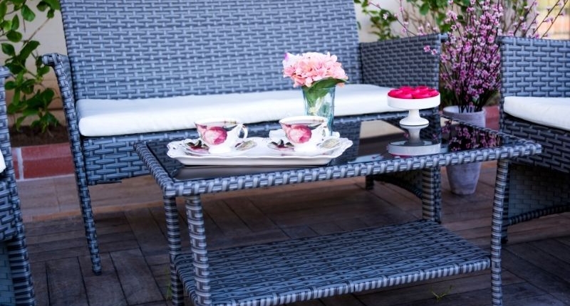 How To Create A Summer-Ready Patio - Blue rattan patio furniture with a lovely china tea set.