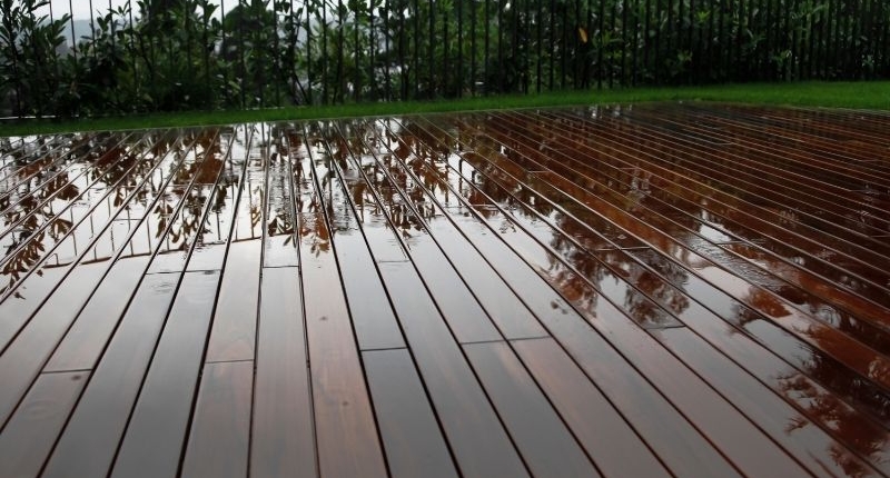 How To Create A Summer-Ready Patio - a clean wet wooden patio recently washed.