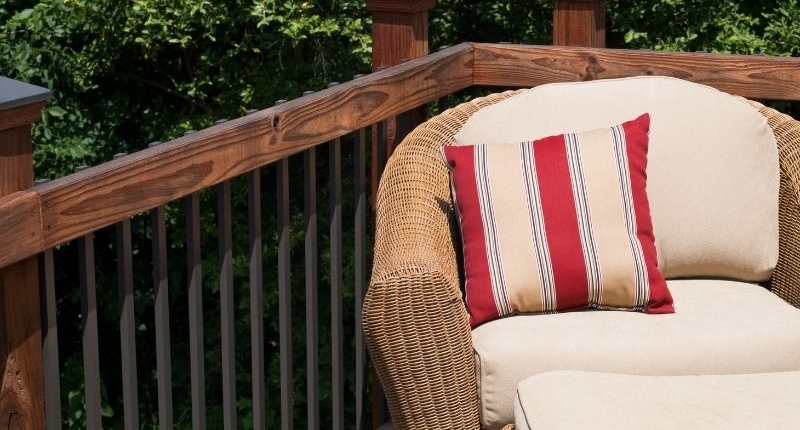 How To Create A Summer-Ready Patio - Earthy yet bright cushions on rattan and linen patio furniture.