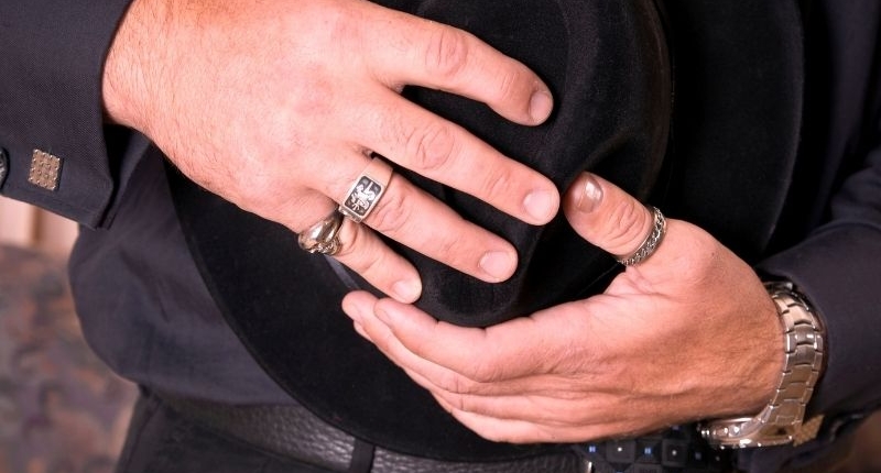 Man wearing multiple rings for how to style your rings for the holidays