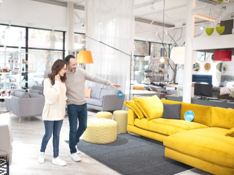 How To Choose the Right Furniture Store for Your Needs - Young couple shopping for furniture.