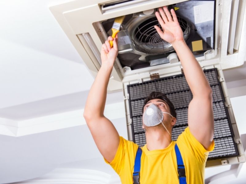 Professional performing repairs on an HVAC System Installation